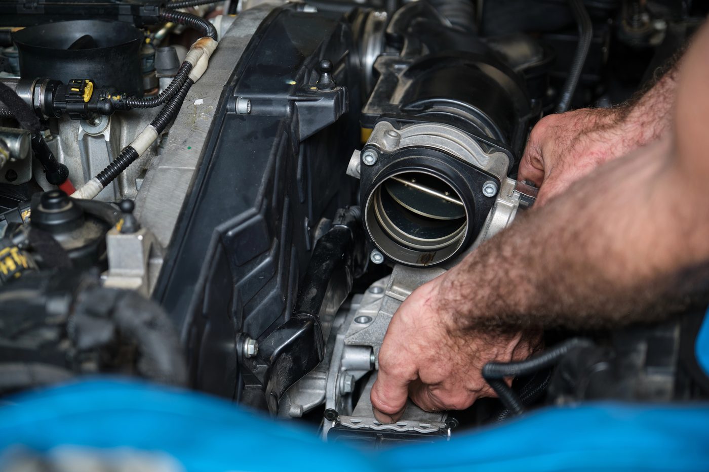 Technician working on a European engine at Elite Euro Performance in Norcross, GA