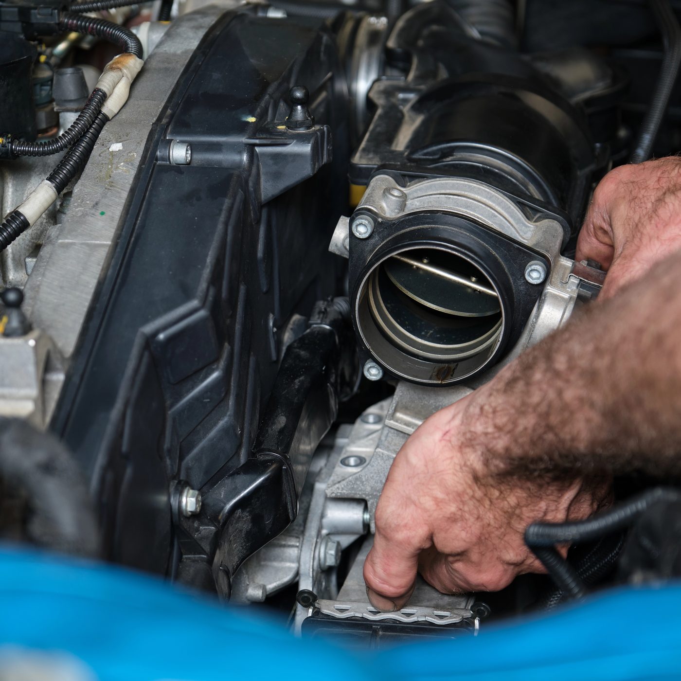 Technician working on a European performance engine in the workshop